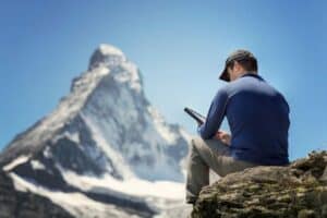 Man with tablet looking at mt whitney being inspired